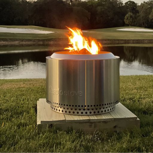 a solo stove on wood on grass